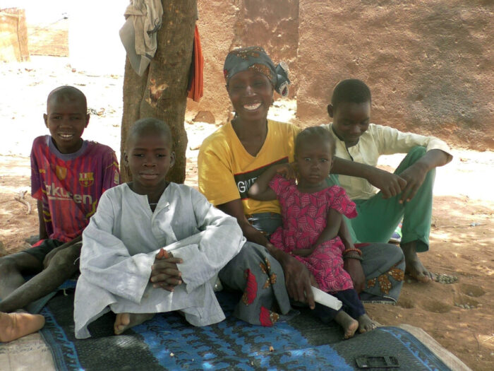 Woman and children sitting under a tree in Cameroon