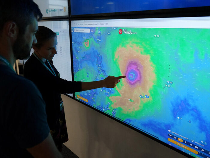 People in ShelterBox office tracking a storm on a screen