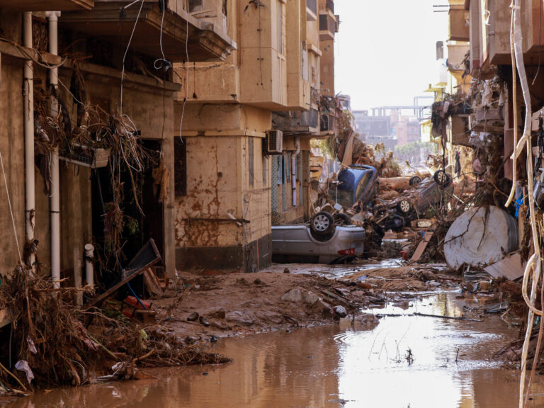 Overturned cars lay among other debris caused by flash floods in Derna, eastern Libya, on September 11, 2023