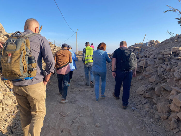People walking through rubble after the earthquake in Morocco