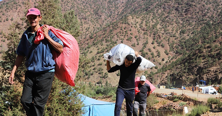People carrying bags of aid in Morocco