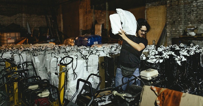 Man carrying a shelter kit in Ukraine