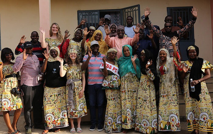 Group of people smiling and waving at the camera in Cameroon