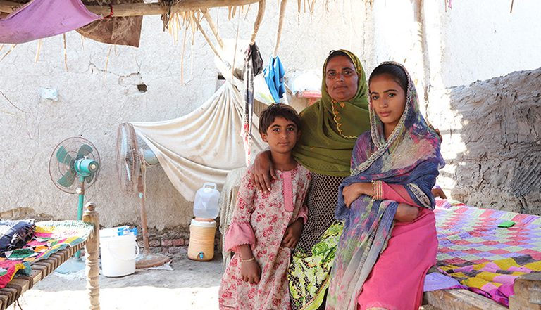 Woman and two girls in a shelter in Pakistan