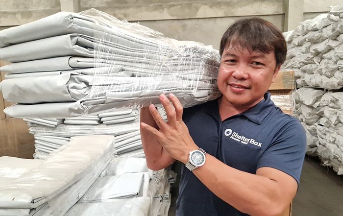 Man carrying aid in warehouse