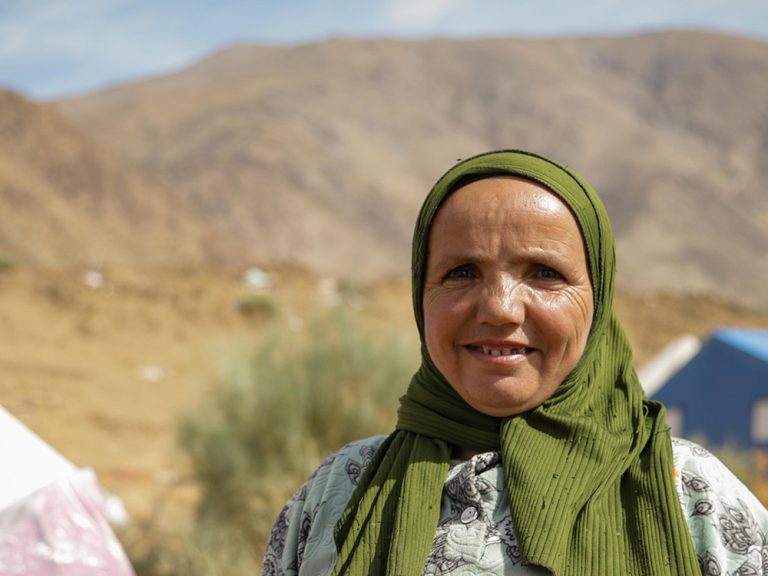 Woman standing next to tents in Atlas Mountains in Morocco