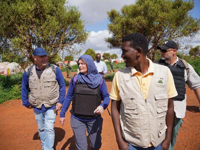 People walking in a displacement camp in Somalia